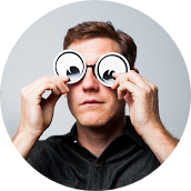 Alex Cook holding googly-eye glasses up to his face